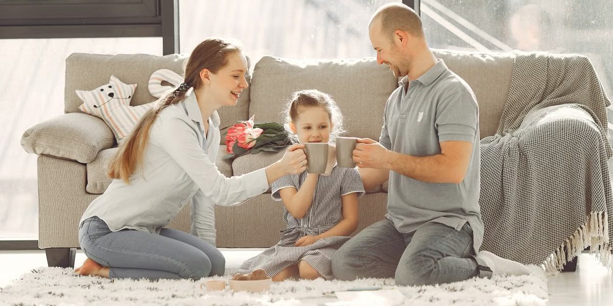A joyful family enjoying quality time and coffee in a bright living room, symbolizing love and togetherness.